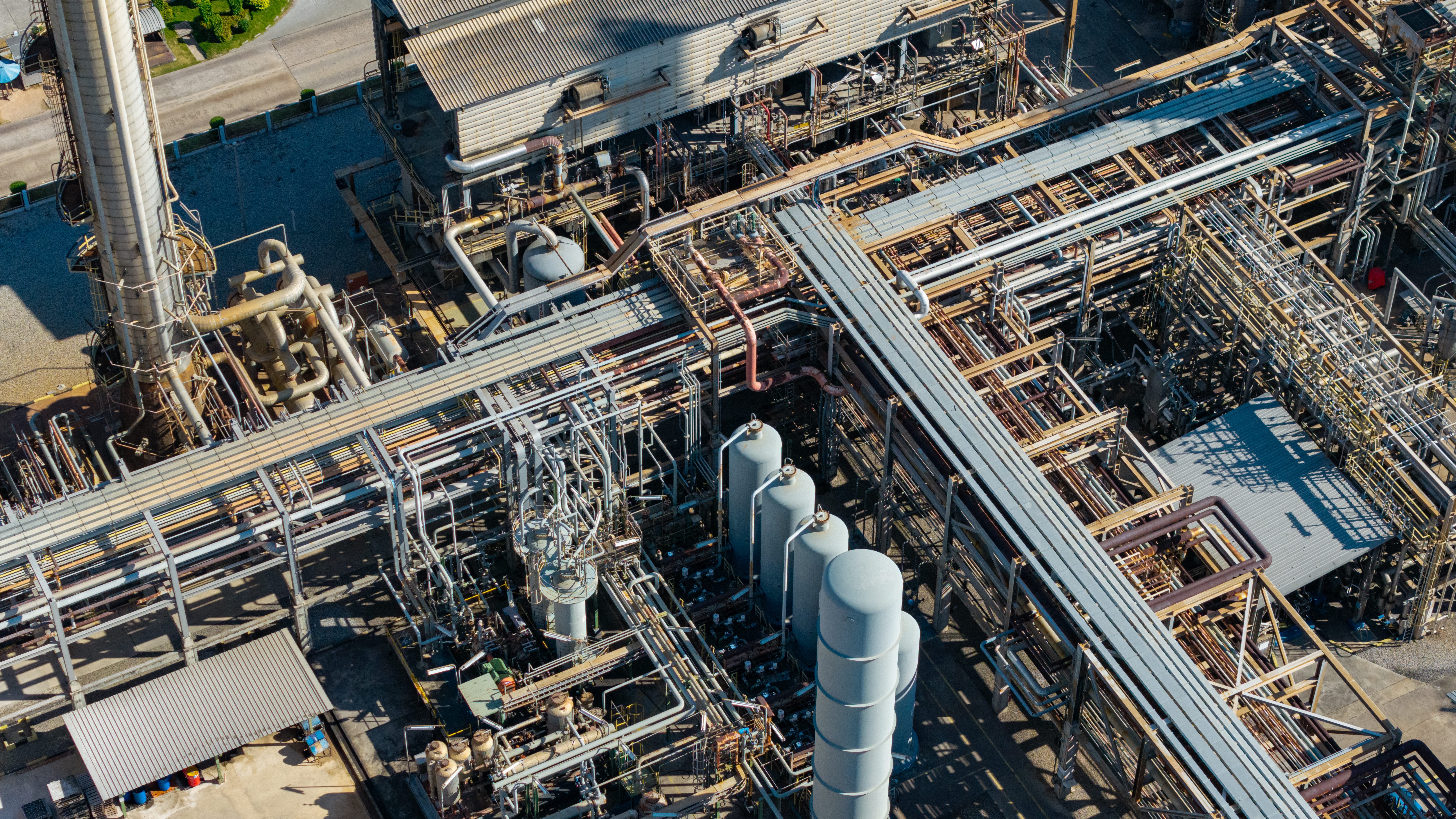 Aerial view of industrial refinery complex with pipelines