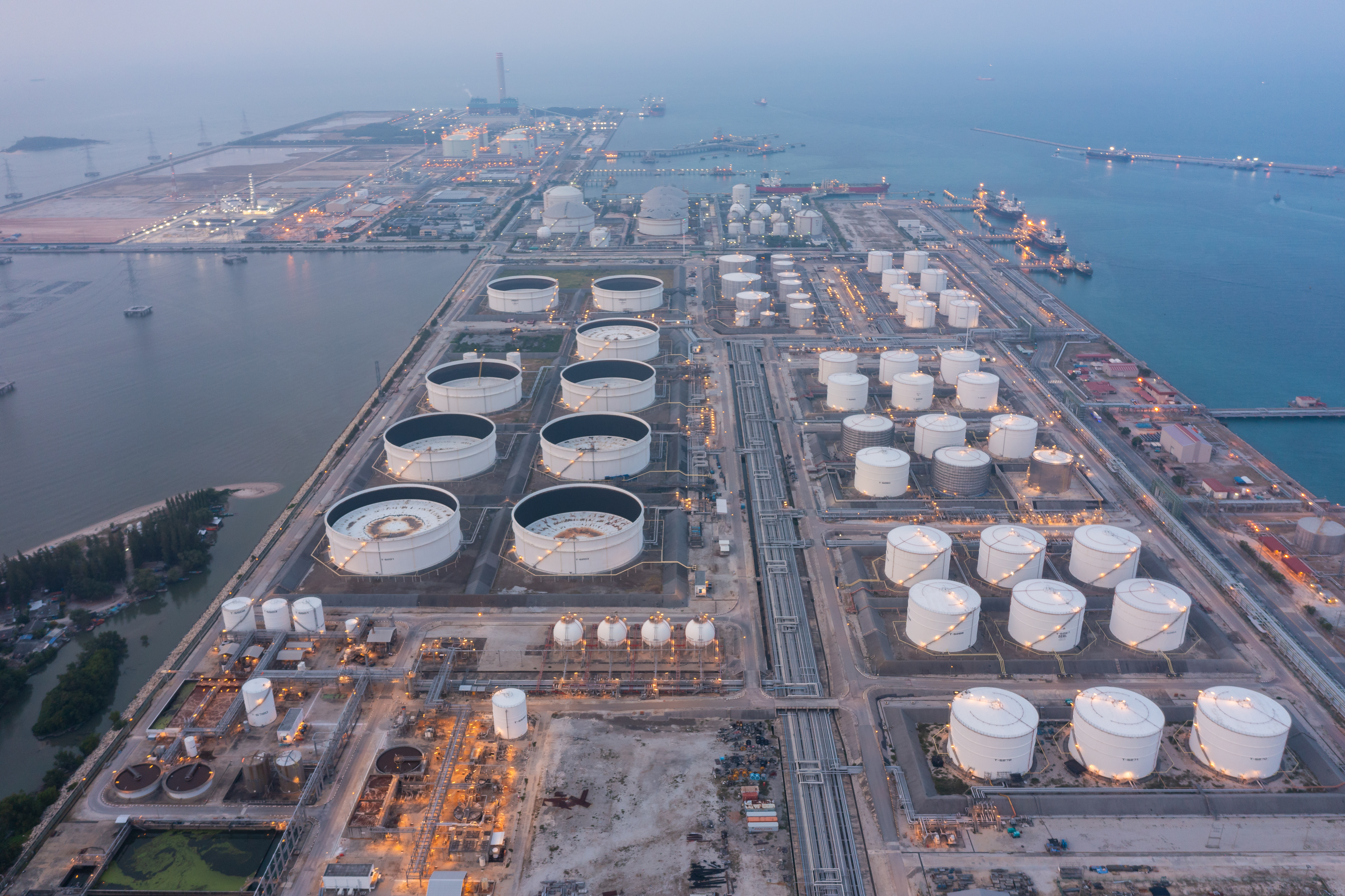Aerial view of oil refinery and sea in industrial engineering