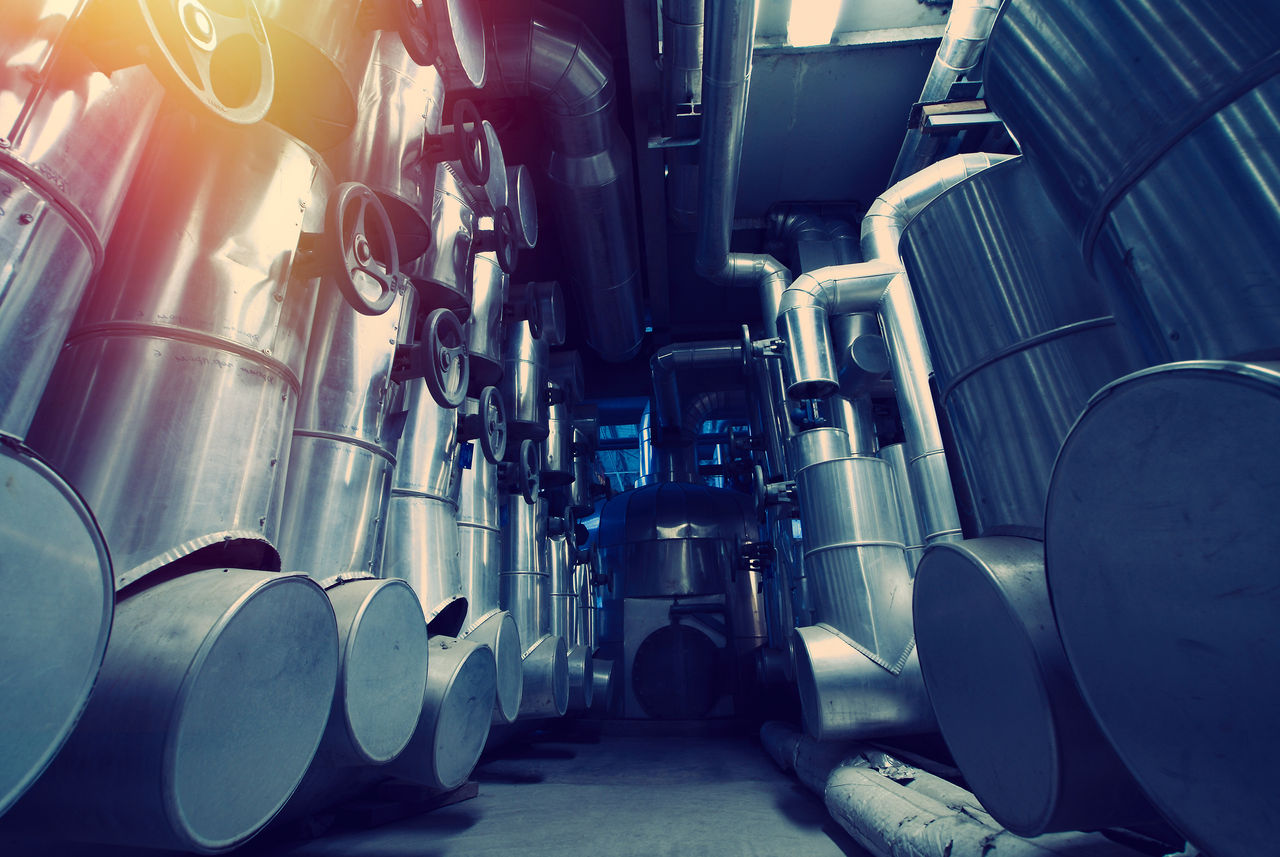 Industrial pipes and valves in factory interior