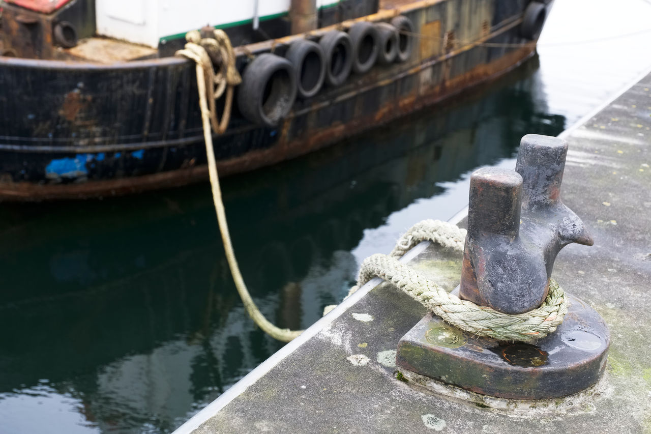 Mooring bollard with rope securing docked boat
