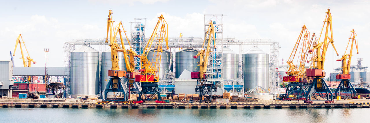 Industrial port with cranes and large storage silos