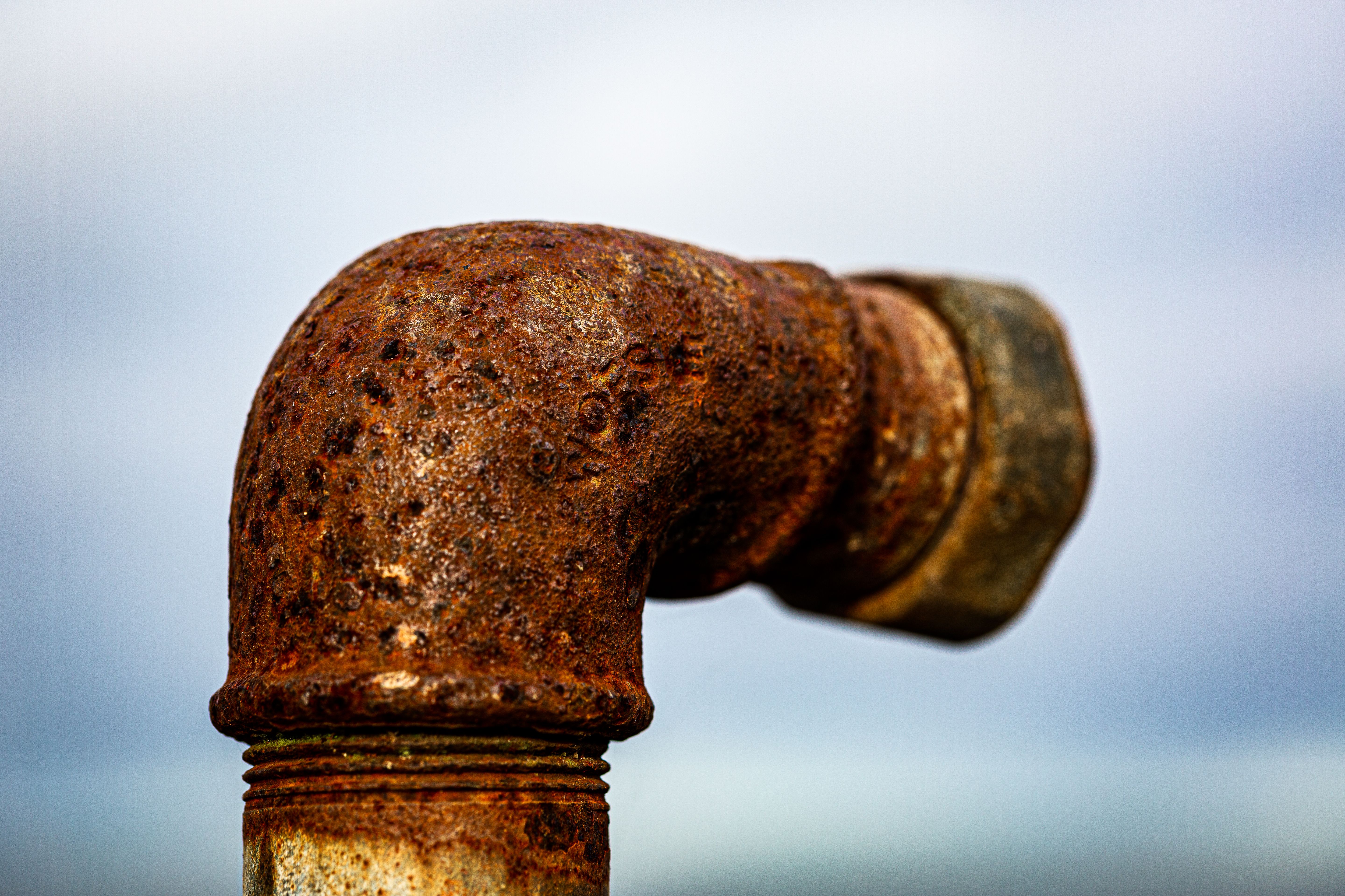 Close-up of rusty metal pipe against sky