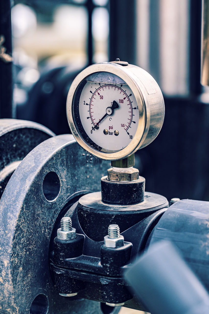 Industrial pressure gauge on metal pipe system