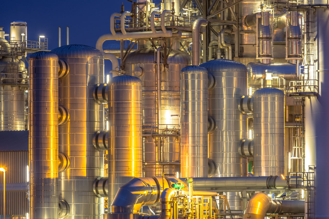 Industrial refinery towers illuminated at night