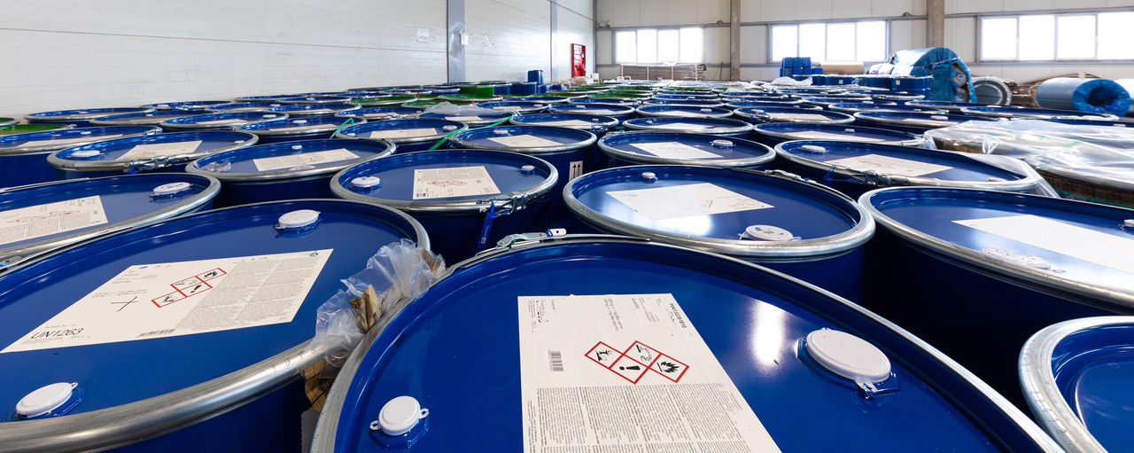 Industrial blue chemical drums in warehouse storage