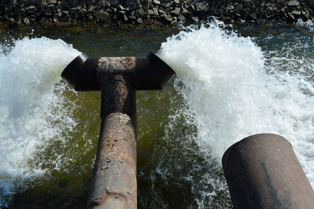 Industrial pipes discharging water into river channel
