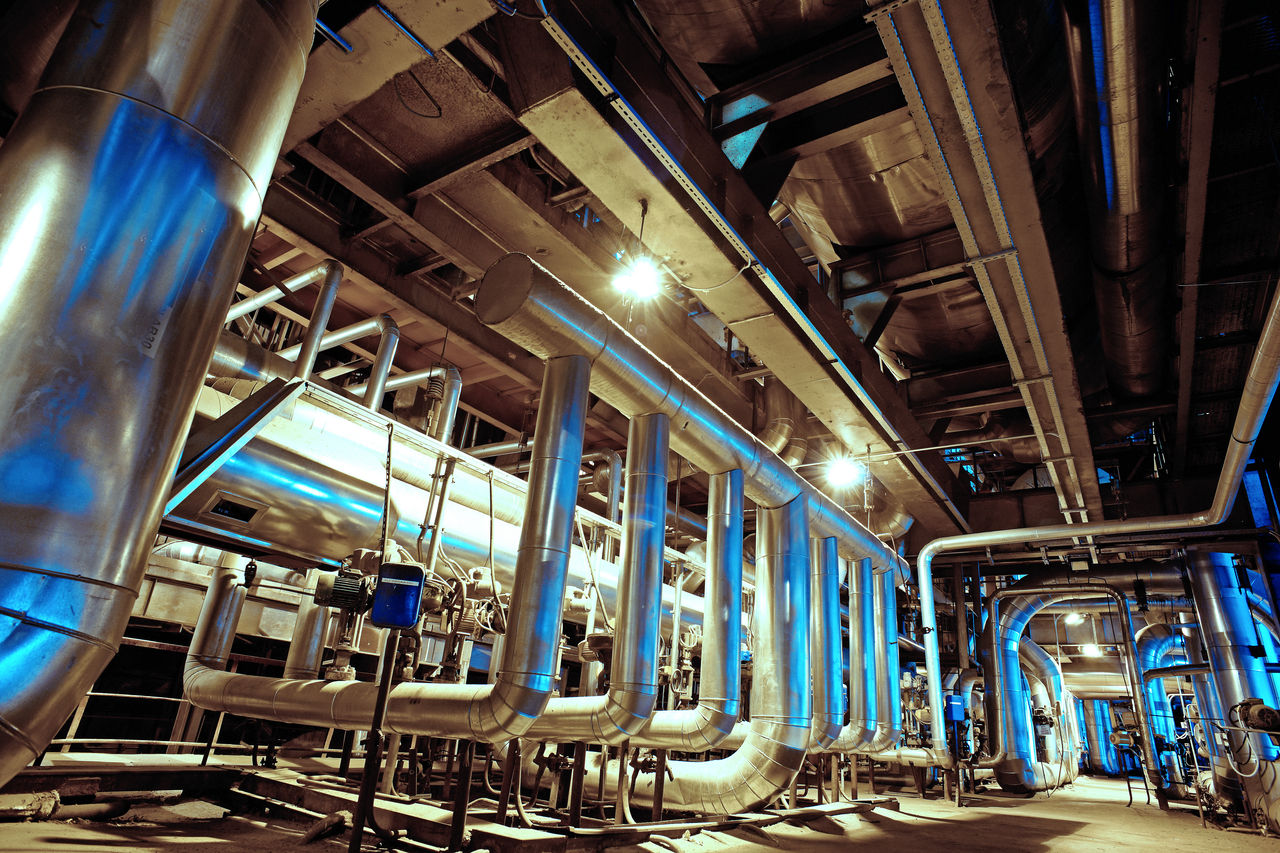 Industrial facility interior with large metal pipes
