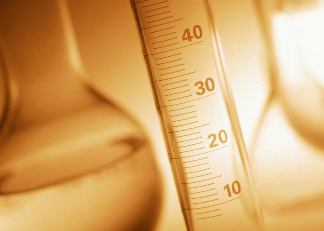 Close-up of graduated cylinder in laboratory setting