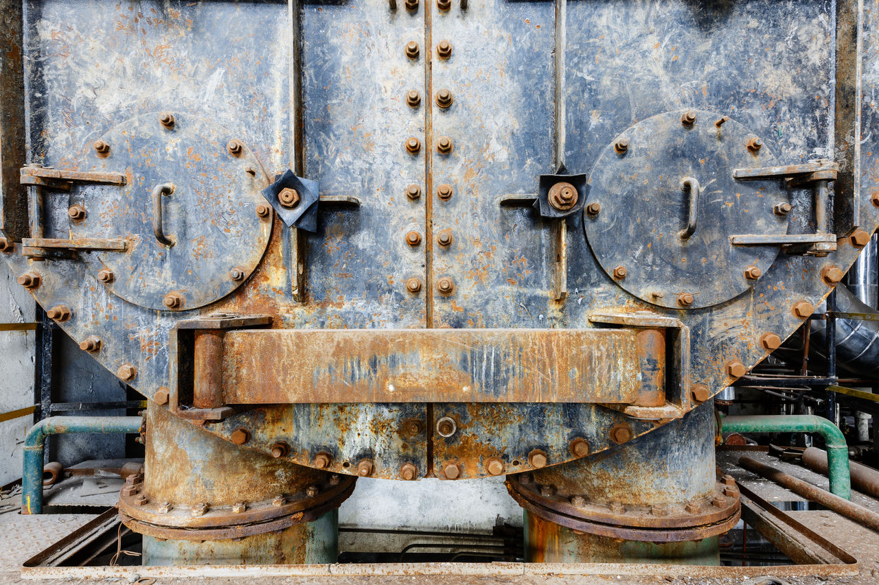 Close-up of rusted industrial metal machinery surface